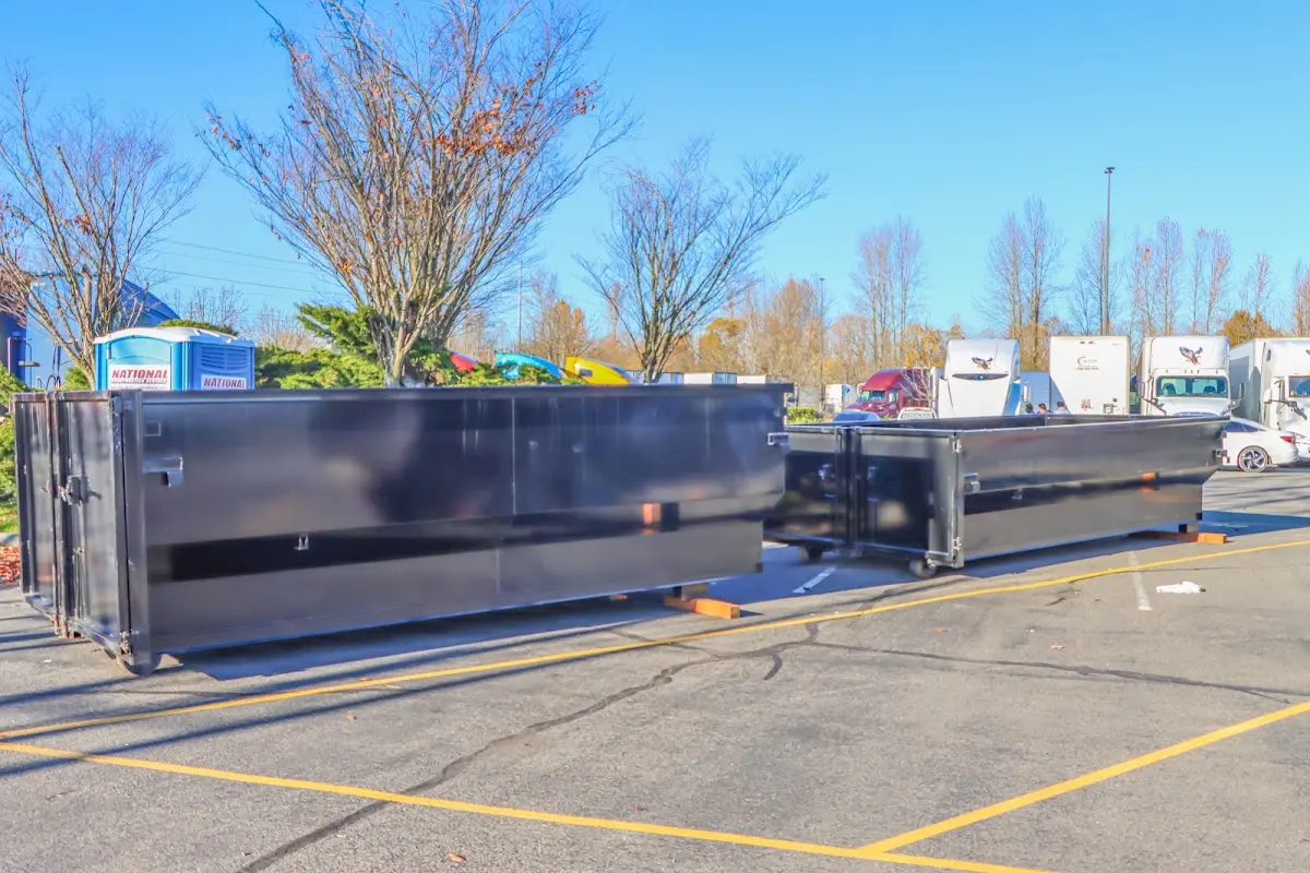 Professional dumpster rental service with roll-off container on residential driveway in Redmond